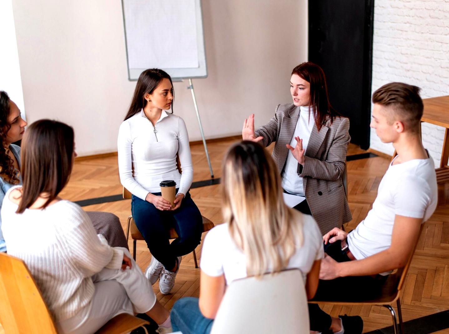 Team meeting discussing investment strategies and educational content development